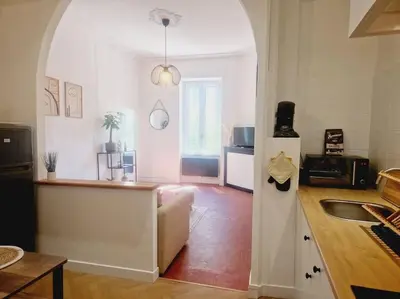 a kitchen with an archway in the middle of a room at Appartement Centre Ville Les Halles - Grands Buffets in Narbonne