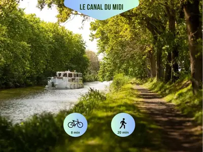 a picture of a boat on a river with three stickers at Vue imprenable cité Carcassonne - 4 personnes in Carcassonne