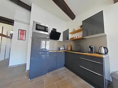 a kitchen with blue cabinets and a counter top at Vue imprenable cité Carcassonne - 4 personnes in Carcassonne