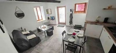 a living room with a couch and a table at Maison Puylaurentaise in Puylaurens