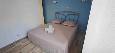 a bedroom with a bed with a cross on it at Maison Puylaurentaise in Puylaurens