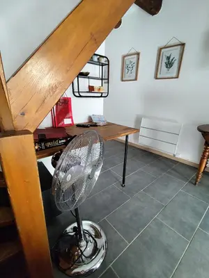 a fan in a room with a desk and stairs at Les flamants roses in Port-la-Nouvelle