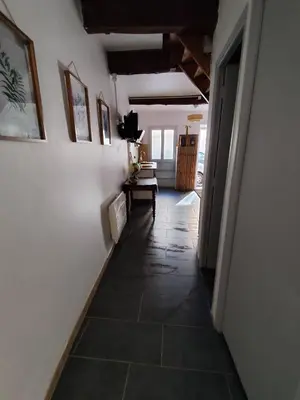 a hallway with a tile floor in a house at Les flamants roses in Port-la-Nouvelle