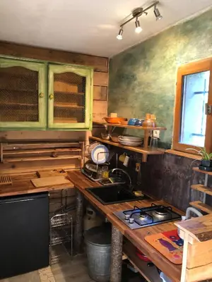 a kitchen with a sink and a stove in it at Le Jardin in Rennes-les-Bains