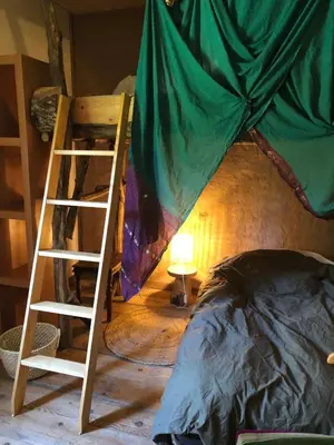a room with a bed and a ladder next to a bunk bed at Le Jardin in Rennes-les-Bains