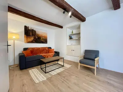 a living room with a couch and a chair at La Tour de Guet in Carcassonne