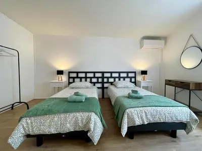 a bedroom with two beds and a mirror at La Tour de Guet in Carcassonne