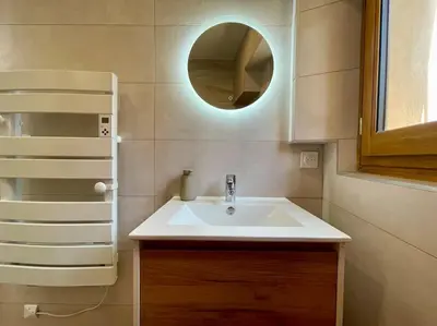a bathroom with a white sink and a mirror at La Tour de Guet in Carcassonne