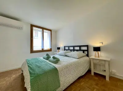 a bedroom with a bed with two stuffed animals on it at La Tour de Guet in Carcassonne