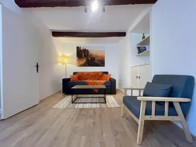 a living room with a blue couch and a table at La Tour de Guet in Carcassonne