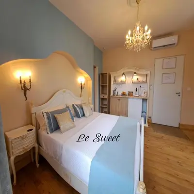 a bedroom with a bed with a be sweet sign on it at La Maison du Canal - Homps - Le Sweet in Homps