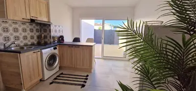 a kitchen with a sink and a washing machine at Maison à louer in Narbonne