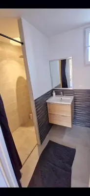 a bathroom with a sink and a mirror at Maison à louer in Narbonne