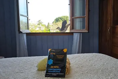a box sitting on top of a bed with a window at L'Oustal 3 chambres avec grand jardin parking gratuit in Bram