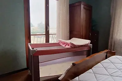 a bed in a room with a window and a bed frame at L'Oustal 3 chambres avec grand jardin parking gratuit in Bram