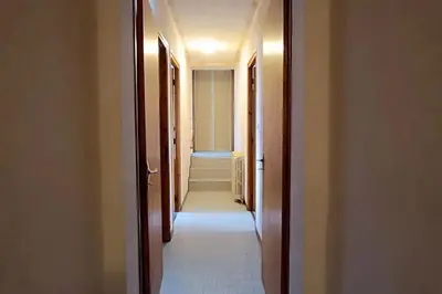 an empty hallway with an open door with a hallwayngthngthngthngthngthngth at L'Oustal 3 chambres avec grand jardin parking gratuit in Bram