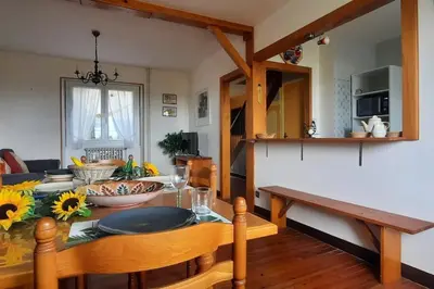 a living room with a table and a kitchen at Terrasse avec vue-Spa-Clim sur les 2 niveaux-Famille-Vacances-Week-end in Preixan