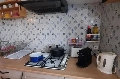 a kitchen counter with a stove with a pot on it at Terrasse avec vue-Spa-Clim sur les 2 niveaux-Famille-Vacances-Week-end in Preixan