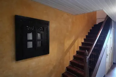 a staircase in a house with a picture on the wall at Terrasse avec vue-Spa-Clim sur les 2 niveaux-Famille-Vacances-Week-end in Preixan