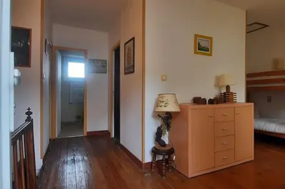a room with a bed and a dresser and a lamp at Terrasse avec vue-Spa-Clim sur les 2 niveaux-Famille-Vacances-Week-end in Preixan