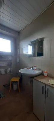 a bathroom with a sink and a mirror and a table at Terrasse avec vue-Spa-Clim sur les 2 niveaux-Famille-Vacances-Week-end in Preixan