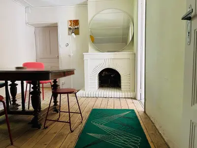 a room with a table and a mirror and a fireplace at Maison de campagne Arty entièrement rénovée 4 chambres in Roquecourbe