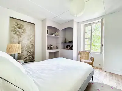 a white bedroom with a large bed and a window at Maison de campagne Arty entièrement rénovée 4 chambres in Roquecourbe