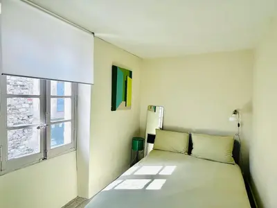 a white bedroom with a bed and a window at Maison de campagne Arty entièrement rénovée 4 chambres in Roquecourbe