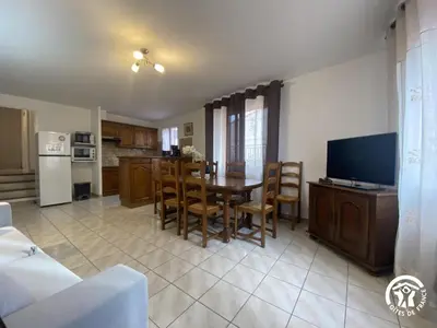 a kitchen and dining room with a table and a television at Grenache rdc in Fosse
