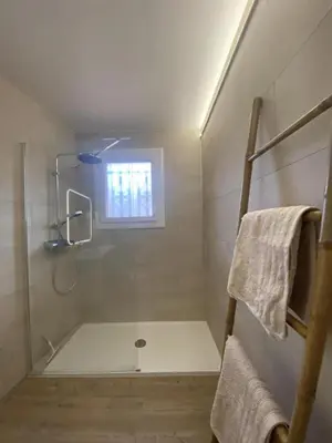 a bathroom with a shower and a window at Grenache rdc in Fosse