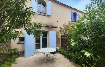 a table and chair in front of a house at Lovely Home In Saint Laurent De La Ca in Saint-Laurent-de-la-Cabrerisse