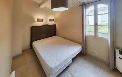 a small bedroom with a bed and a window at Lovely Home In Saint Laurent De La Ca in Saint-Laurent-de-la-Cabrerisse