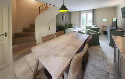 a dining room with a wooden table and chairs at Lovely Home In Saint Laurent De La Ca in Saint-Laurent-de-la-Cabrerisse