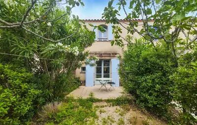 a house with a table in front of it at Lovely Home In Saint Laurent De La Ca in Saint-Laurent-de-la-Cabrerisse