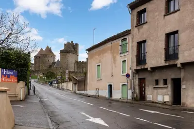 an empty street in front of a castle at Le Logis de Joseph au pied de la Cité Médiévale in Carcassonne