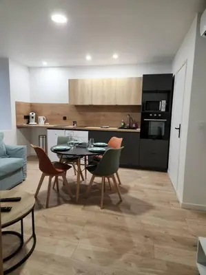 a kitchen and dining room with a table and chairs at Le Maillot IV in Castres