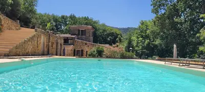 a large swimming pool in front of a building at Magnifique Mas avec Piscine - La Bergerie du Razès in Alet-les-Bains