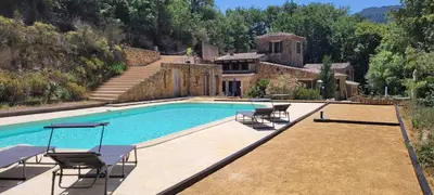a swimming pool with chairs and a house at Magnifique Mas avec Piscine - La Bergerie du Razès in Alet-les-Bains