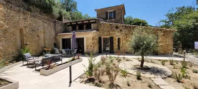 a stone house with a patio with a tree at Magnifique Mas avec Piscine - La Bergerie du Razès in Alet-les-Bains