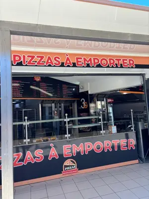 a pizza as a emporium with a sign in the window at T2 moderne à 2 min de la plage in Port-la-Nouvelle