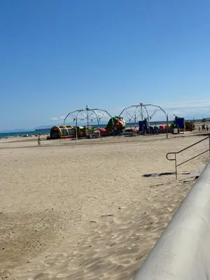 a sandy beach with a playground in the background at T2 moderne à 2 min de la plage in Port-la-Nouvelle