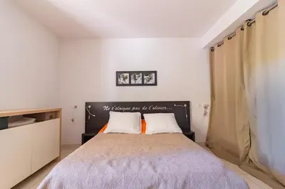 a bedroom with a large bed with two pillows at Douceur de Jouarres - Avec piscine in Azille