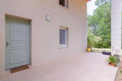 a white house with a door and a courtyard at Douceur de Jouarres - Avec piscine in Azille