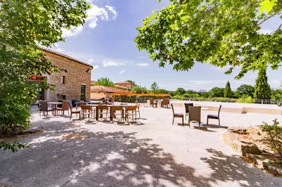 a group of tables and chairs in a courtyard at Douceur de Jouarres - Avec piscine in Azille