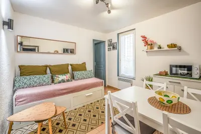 a small living room with a couch and a table at Le Cocon Urbain in Narbonne
