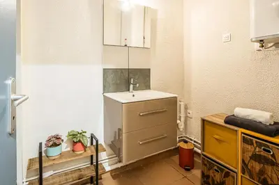 a small kitchen with a sink and a counter at Le Cocon Urbain in Narbonne