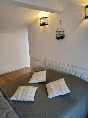a room with a bed with two pillows on it at Charmante Petite Maison Audoise in Trausse