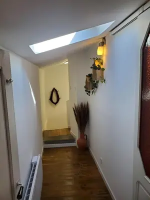 a hallway with a skylight in a house at Charmante Petite Maison Audoise in Trausse
