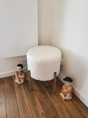two dolls sitting on the floor next to a stool at Charmante Petite Maison Audoise in Trausse
