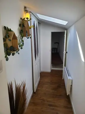 a hallway with an open door and a stairway at Charmante Petite Maison Audoise in Trausse